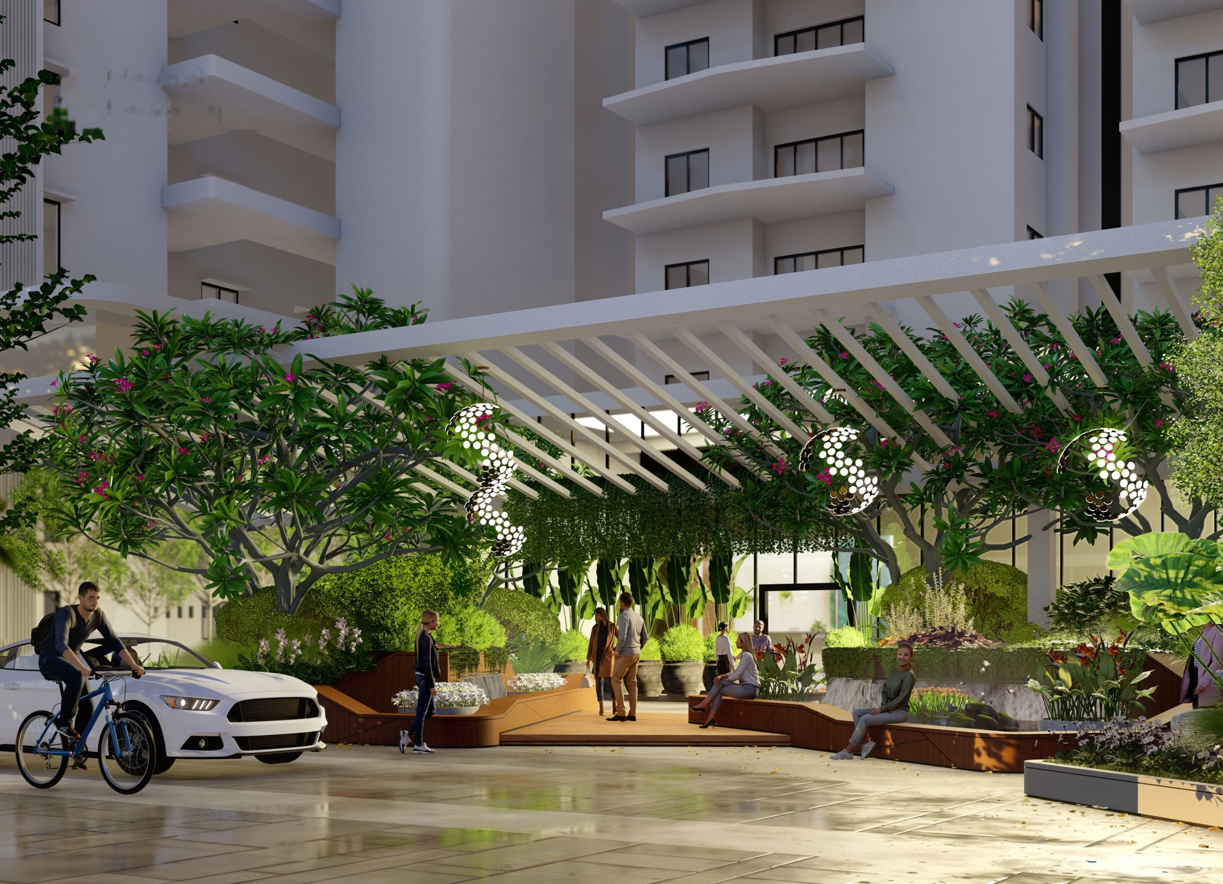 Landscaped entrance with pergola, flowering trees and seating at Lumbini Elysee